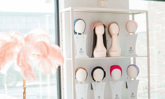 Different styles and colors of wig hats for hair loss on display.